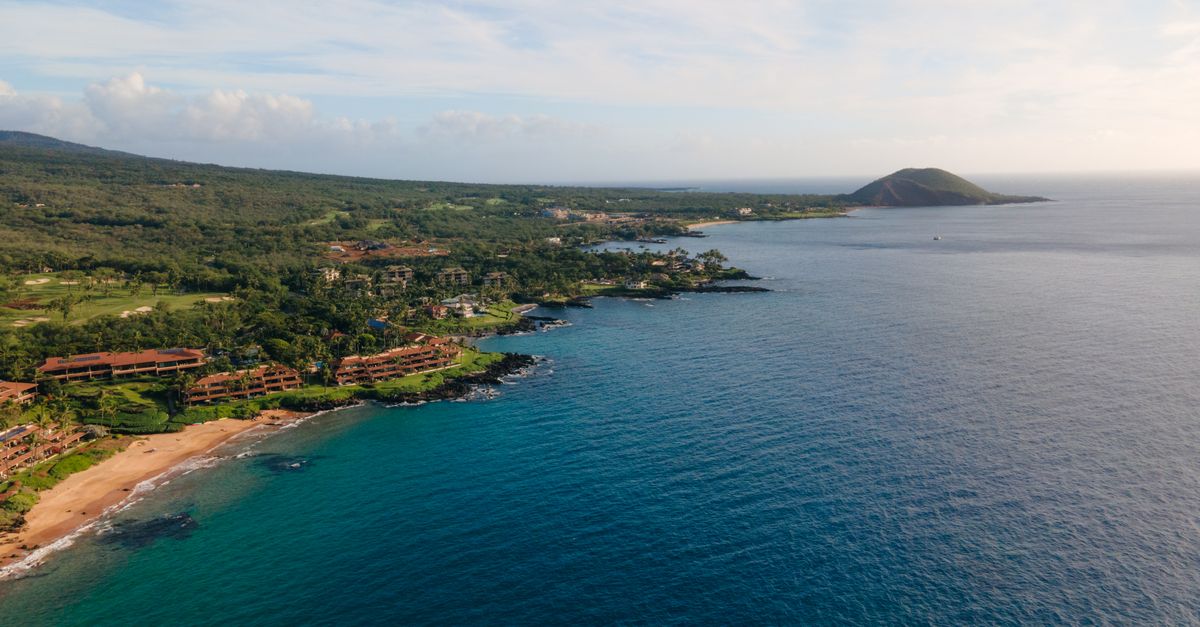 Stunning aerial view of the lush Wailea-Makena coastline in Maui, Hawaii with clear blue ocean waters.